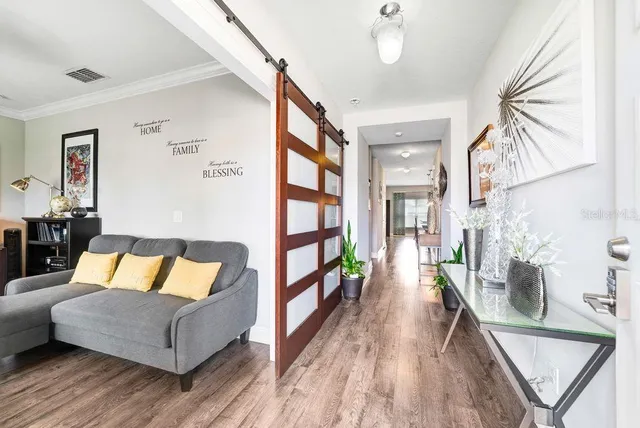 a living room with furniture and a wooden floor