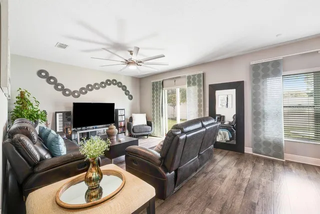 a living room with furniture a fireplace and a flat screen tv