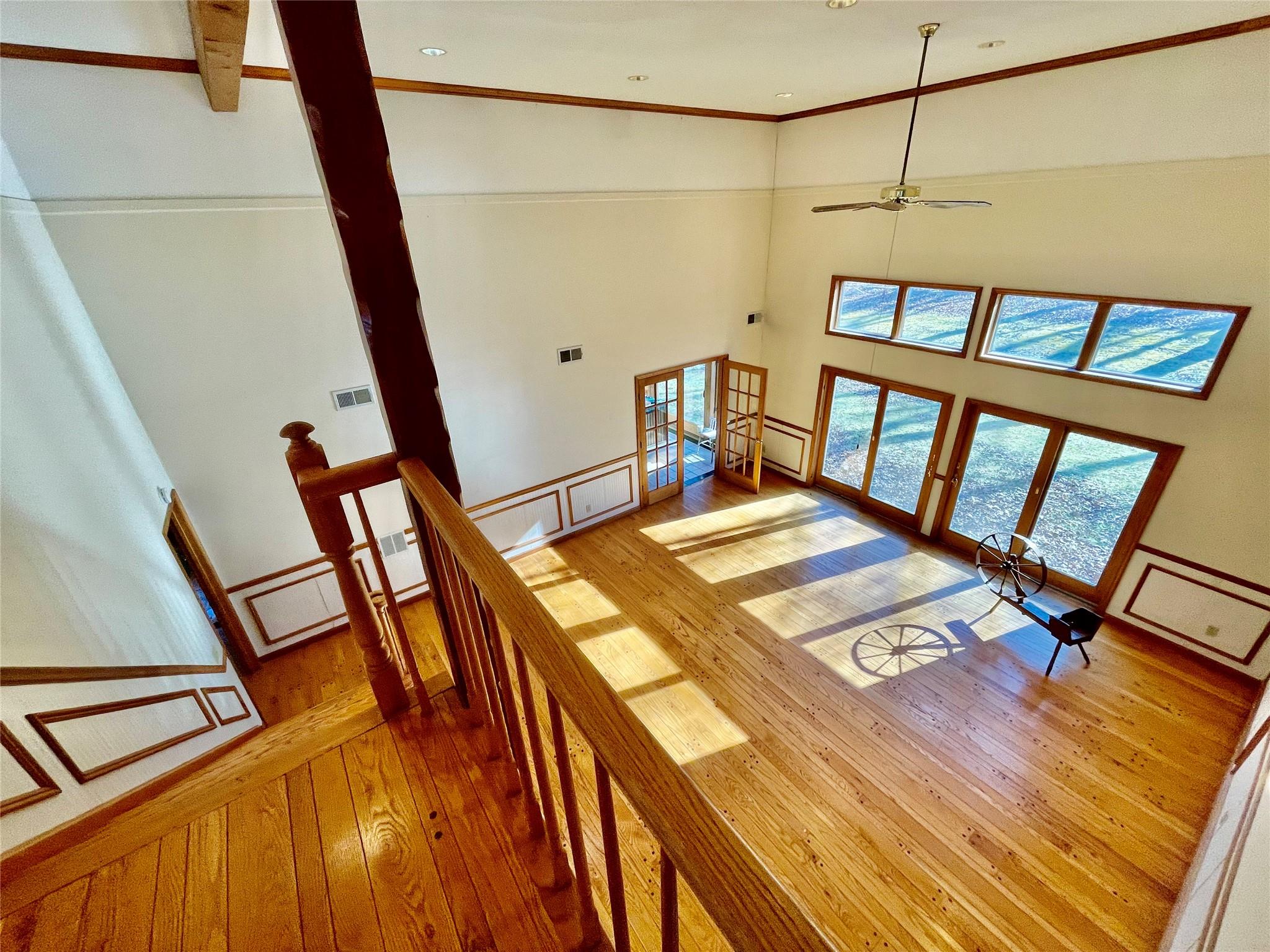 71 Saddleback Ridge Wallkill, NY 12589 - Photo 22 of 39 Stairway featuring hardwood / wood-style flooring, ceiling fan, a high ceiling, crown molding, and recessed lighting