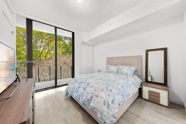 a view of a patio with couches table and chairs and potted plants