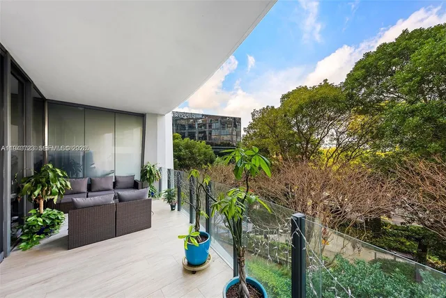 a view of a house with swimming pool and porch with furniture