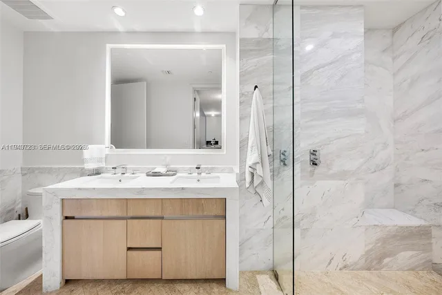 a view of a kitchen with a white cabinets and wooden floor