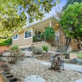 a backyard of a house with outdoor seating
