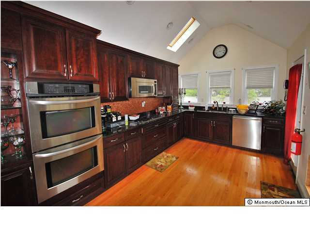 119 Ravine Drive Matawan, NJ 07747 - Photo 3 of 16 a kitchen with a stove and a refrigerator