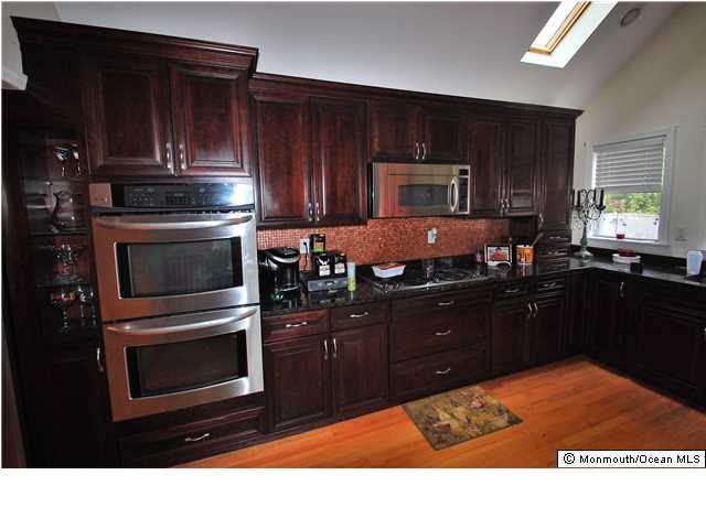 119 Ravine Drive Matawan, NJ 07747 - Photo 4 of 16 a kitchen with a sink stove and microwave