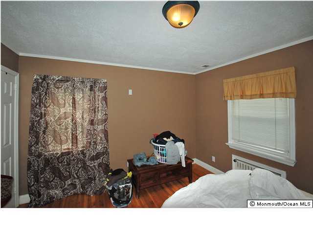 119 Ravine Drive Matawan, NJ 07747 - Photo 7 of 16 a living room with a couch and potted plant
