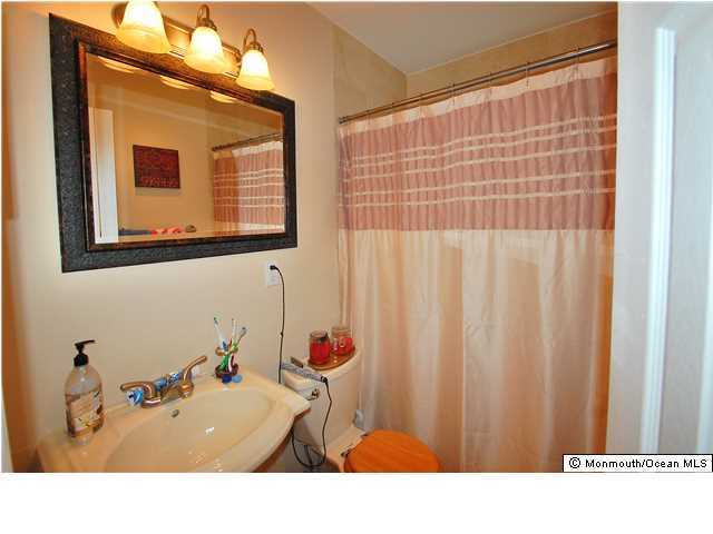 119 Ravine Drive Matawan, NJ 07747 - Photo 9 of 16 a bathroom with a sink and a mirror