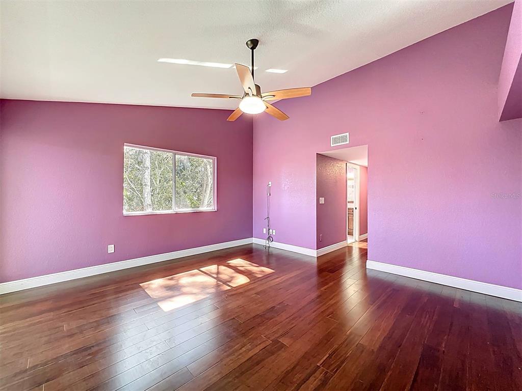 9736 Indian Key Trail, Unit 111 Seminole, FL 33776 - Photo 21 of 56 a view of an empty room with window and wooden floor