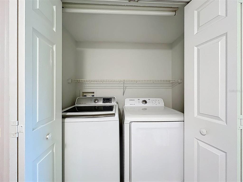 9736 Indian Key Trail, Unit 111 Seminole, FL 33776 - Photo 36 of 56 a utility room with dryer and washer