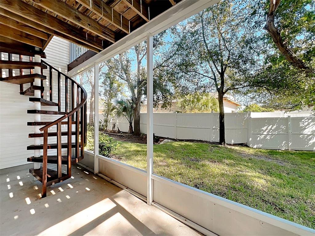 9736 Indian Key Trail, Unit 111 Seminole, FL 33776 - Photo 42 of 56 a view of a porch with wooden floor and fence