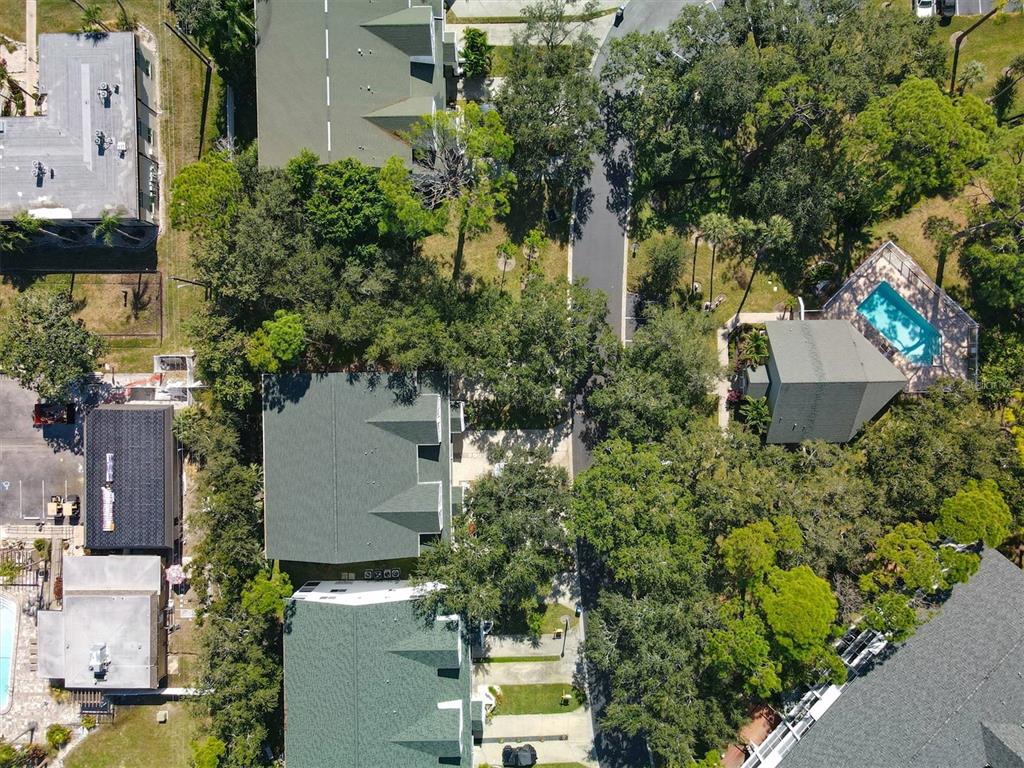 9736 Indian Key Trail, Unit 111 Seminole, FL 33776 - Photo 49 of 56 an aerial view of a house with outdoor space and trees all around