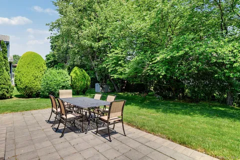 a view of a patio with table and chairs and potted plants