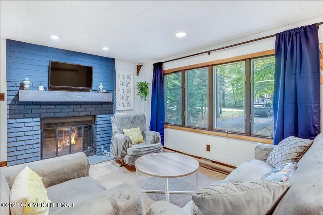 a living room with furniture and a fireplace