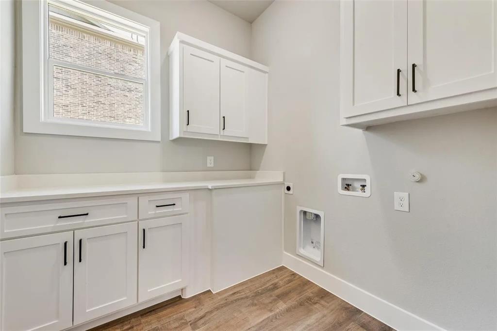 1327 Selby Road Van Alstyne, TX 75495 - Photo 19 of 32 Laundry room featuring electric dryer hookup, light wood finished floors, cabinet space, hookup for a washing machine, and gas dryer hookup