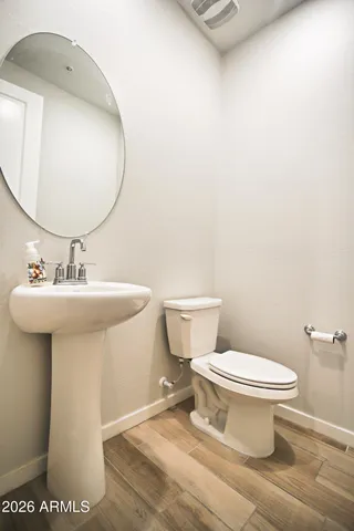 a bathroom with a sink toilet and a mirror