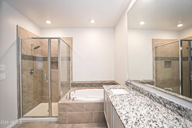 a bathroom with a tub and shower