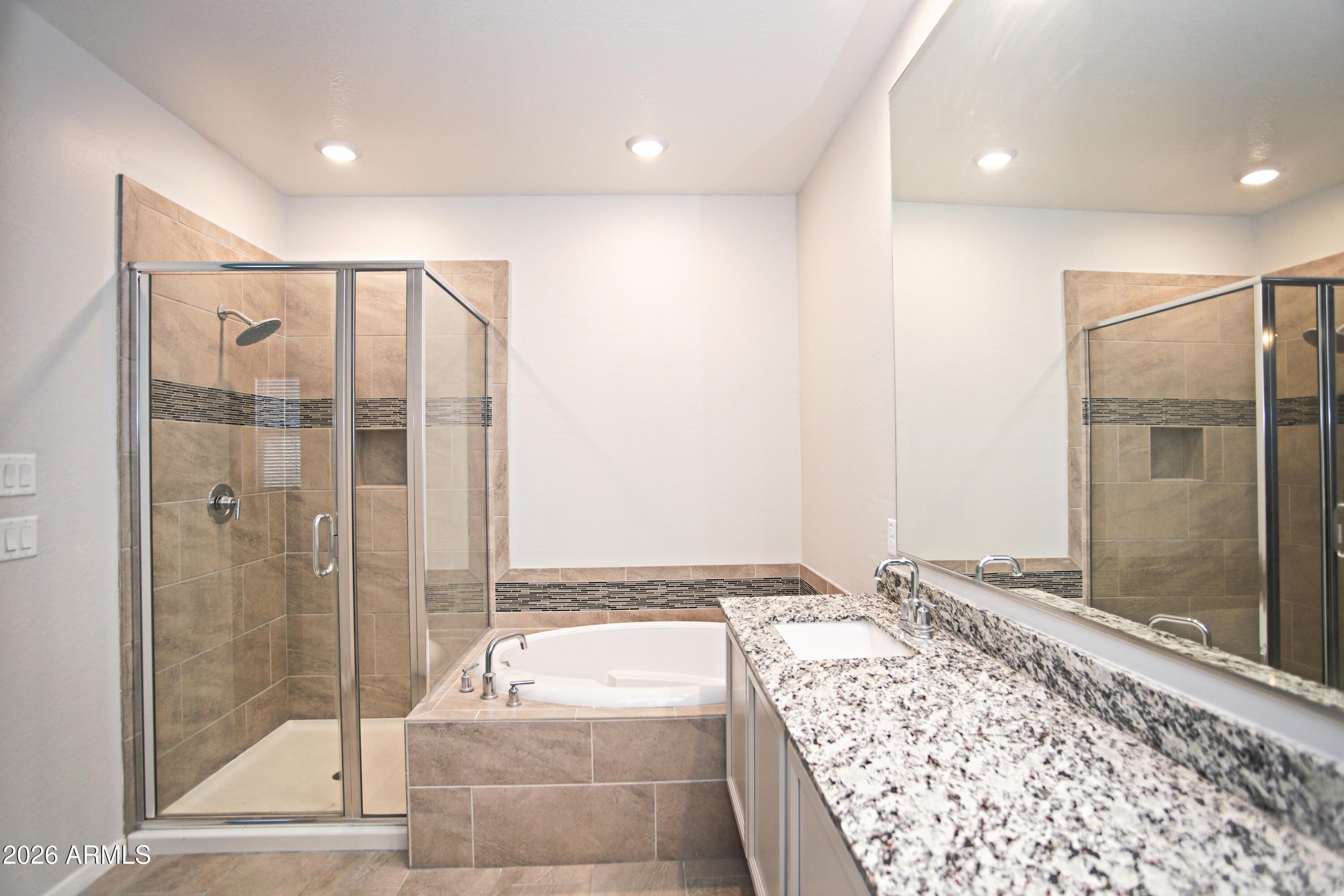 3855 South McQueen Road, Unit 110 Chandler, AZ 85286 - Photo 17 of 37 a bathroom with a tub and shower