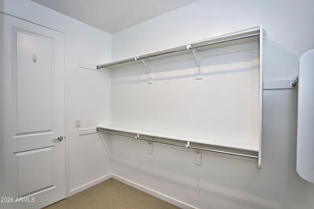 an empty room with a window and a ceiling fan