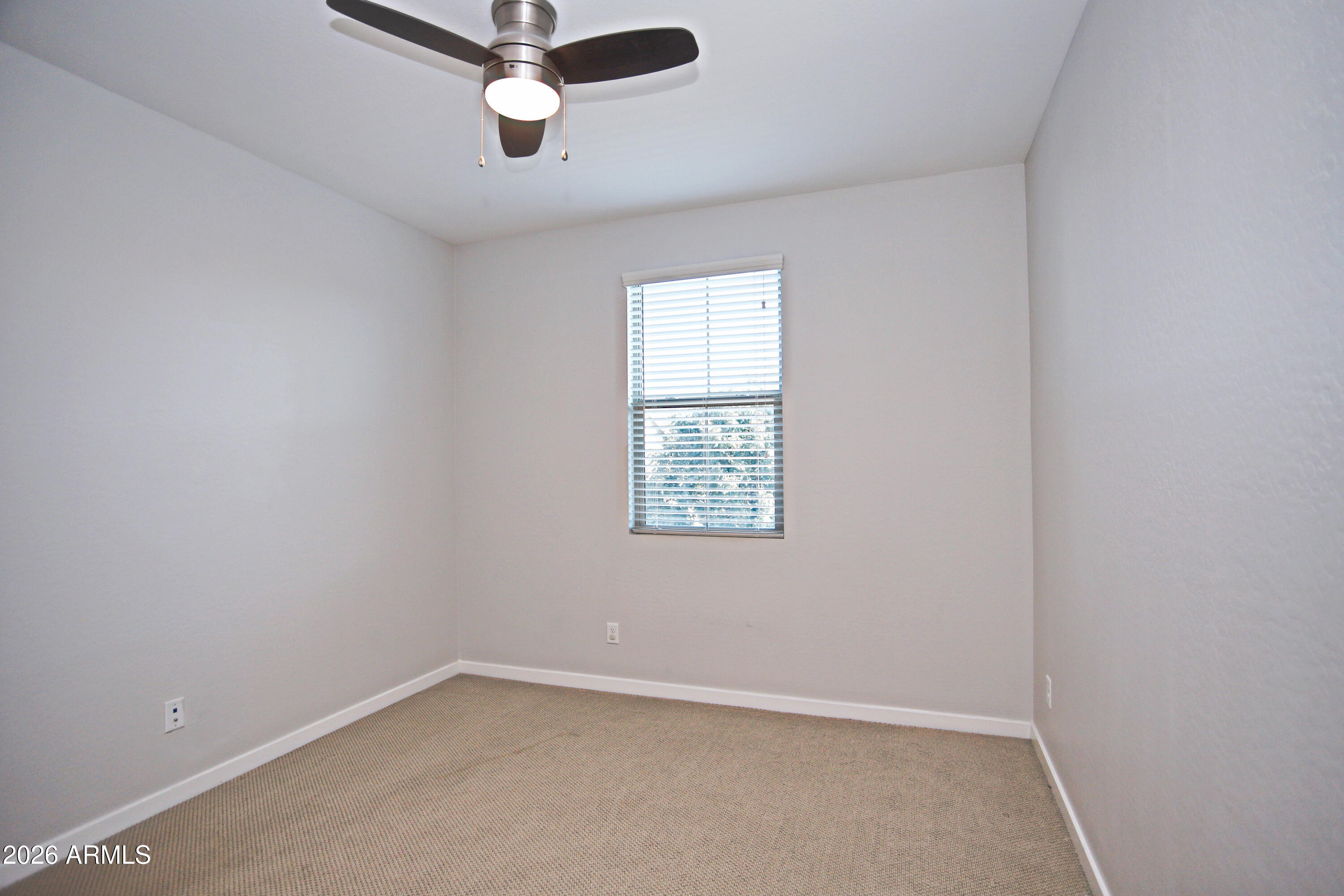 3855 South McQueen Road, Unit 110 Chandler, AZ 85286 - Photo 21 of 37 an empty room with a window and a ceiling fan