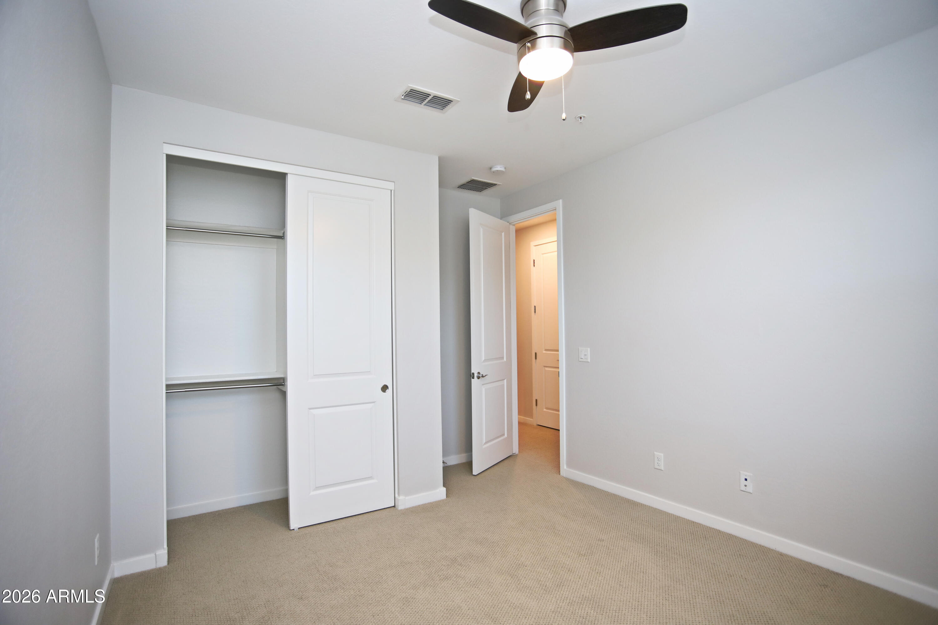 3855 South McQueen Road, Unit 110 Chandler, AZ 85286 - Photo 22 of 37 an empty room with a ceiling fan and window