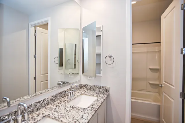 a bathroom with a shower and a bath tub