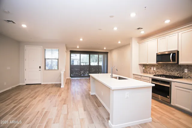 a large kitchen with stainless steel appliances kitchen island a large island in the center