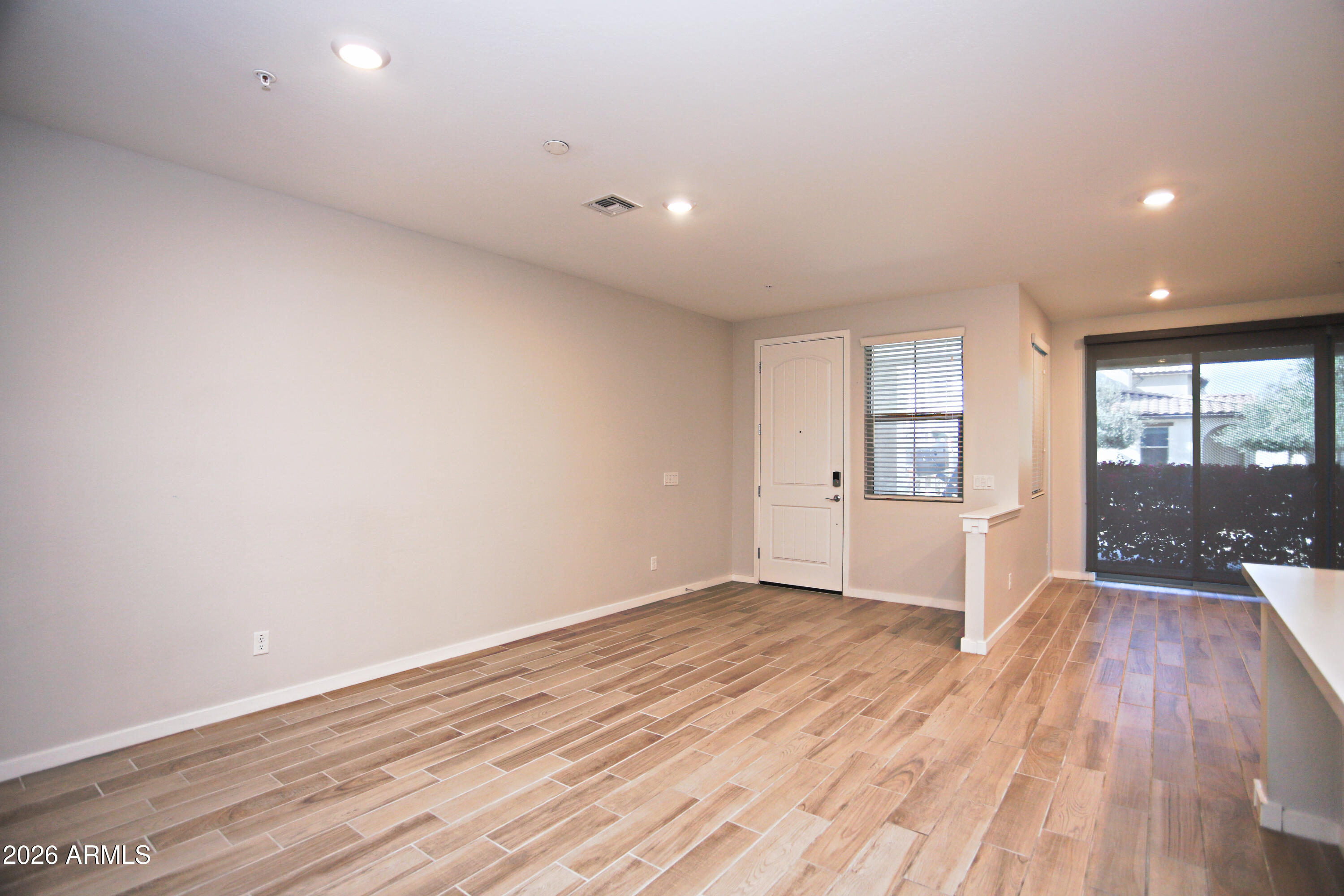 3855 South McQueen Road, Unit 110 Chandler, AZ 85286 - Photo 4 of 37 wooden floor in an empty room with a window