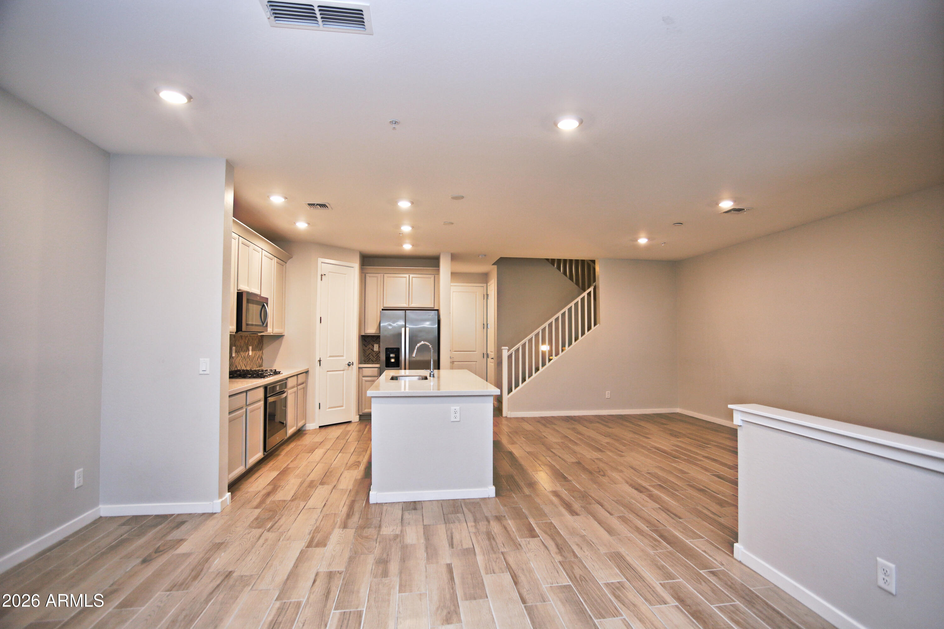 3855 South McQueen Road, Unit 110 Chandler, AZ 85286 - Photo 7 of 37 a view of kitchen with cabinets stainless steel appliances and wooden floor