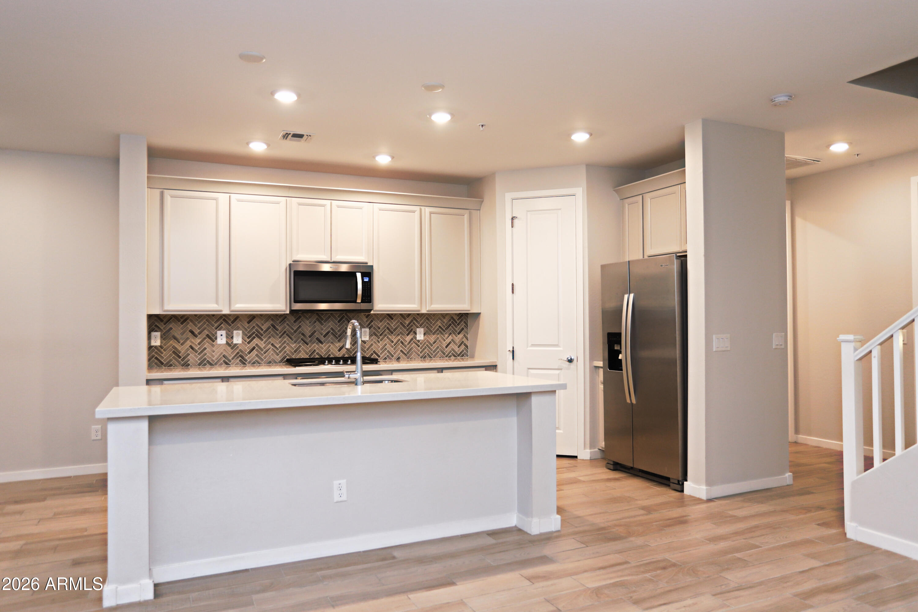 3855 South McQueen Road, Unit 110 Chandler, AZ 85286 - Photo 8 of 37 a kitchen with stainless steel appliances granite countertop a sink a refrigerator and a stove