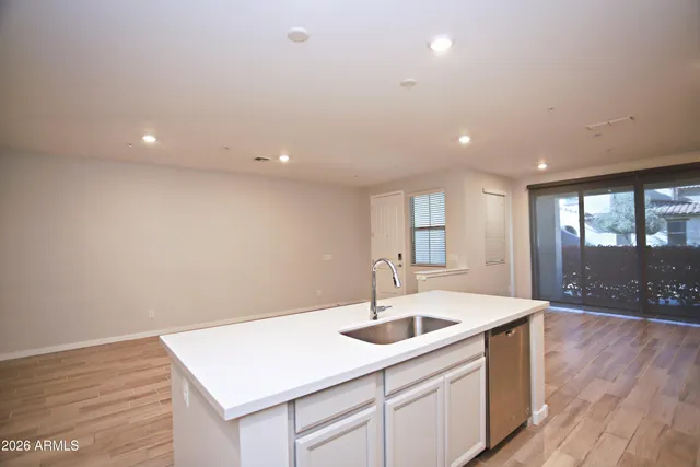 a kitchen with a sink and chandelier