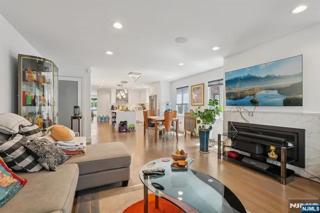 a living room with furniture a lamp and a potted plant