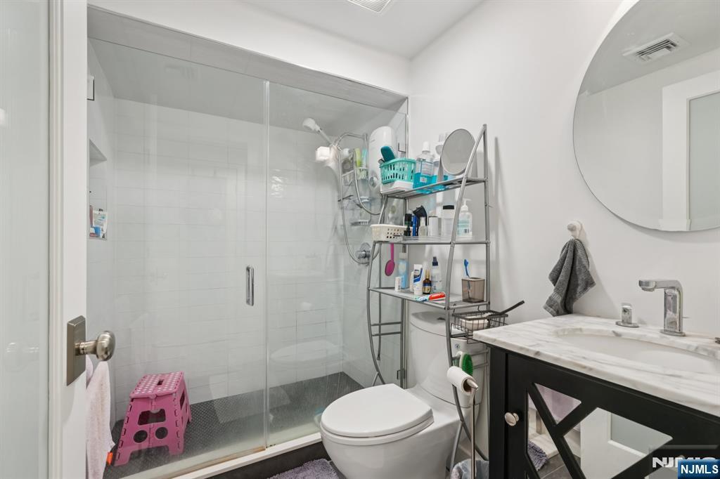 746 Undercliff Avenue, Unit A Edgewater, NJ 07020 - Photo 31 of 44 a bathroom with a granite countertop sink a toilet and shower