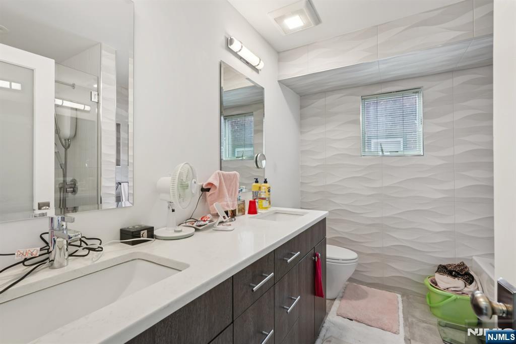 746 Undercliff Avenue, Unit A Edgewater, NJ 07020 - Photo 33 of 44 a bathroom with a double vanity sink mirror and toilet