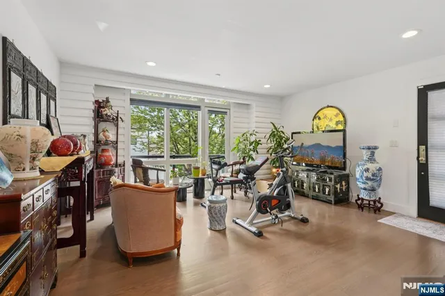 a view of a hallway with wooden floor and entryway