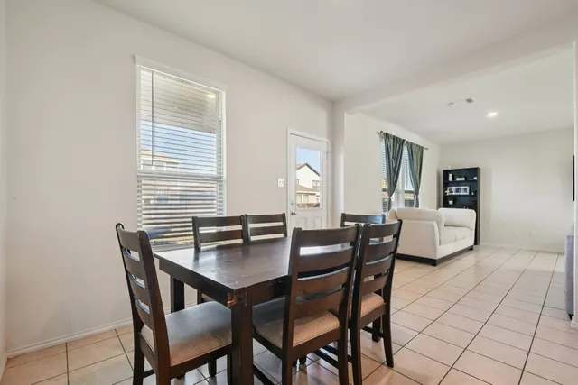 a view of a dining room with furniture and window