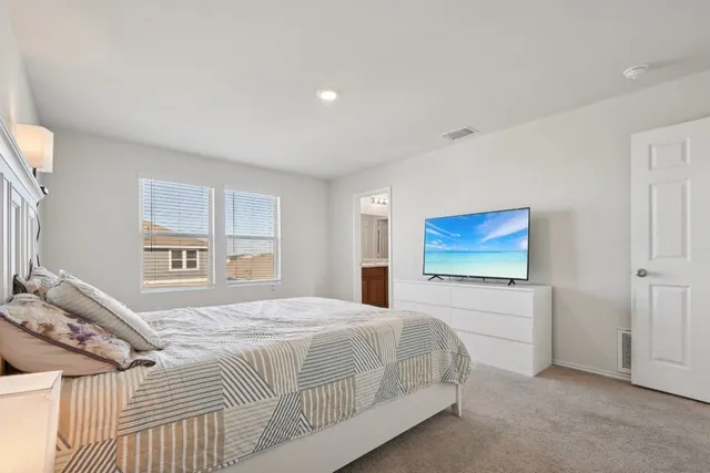 a bedroom with a bed and a view of bedroom