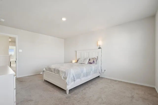 a room with a bed and a night stand