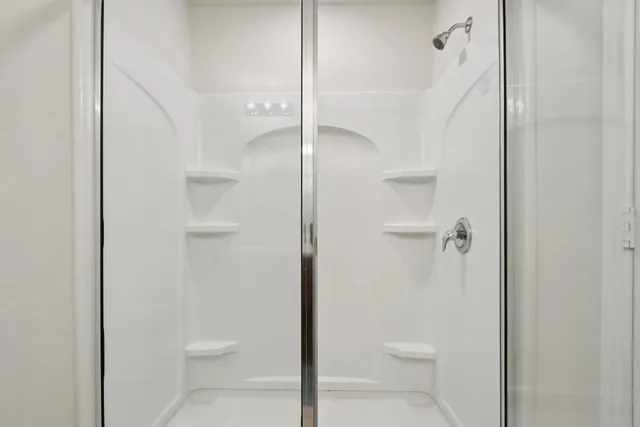 a bathroom that has a glass shower door