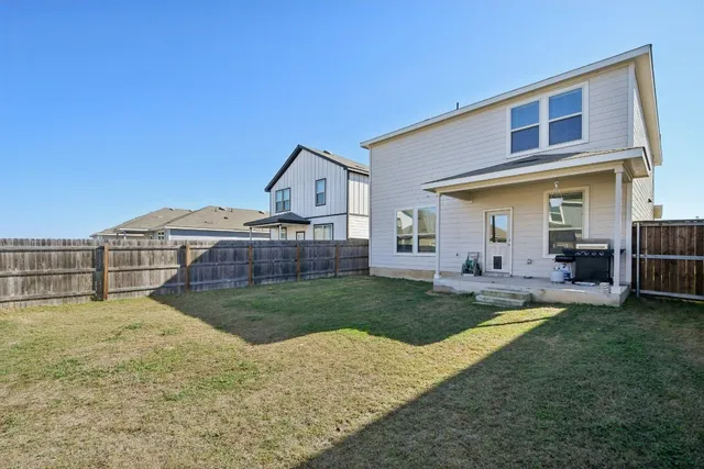 a view of a house with a yard and sitting area