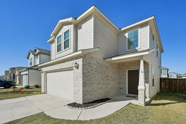 a view of a house with a small yard