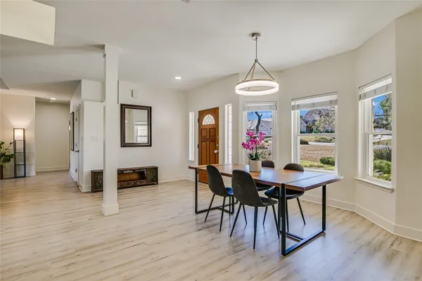 a view of a dining room with furniture window and wooden floor