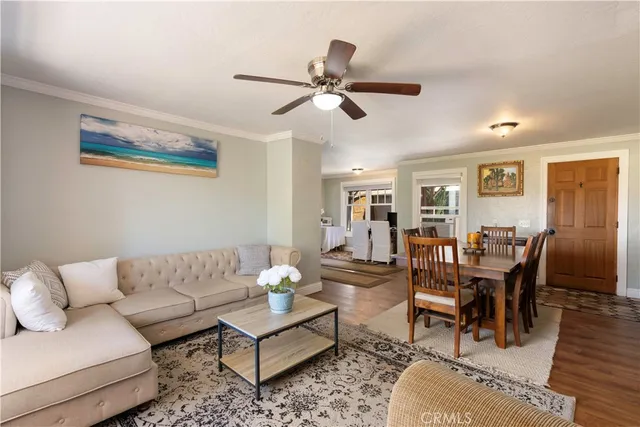 a view of a a dining room with furniture window and wooden floor