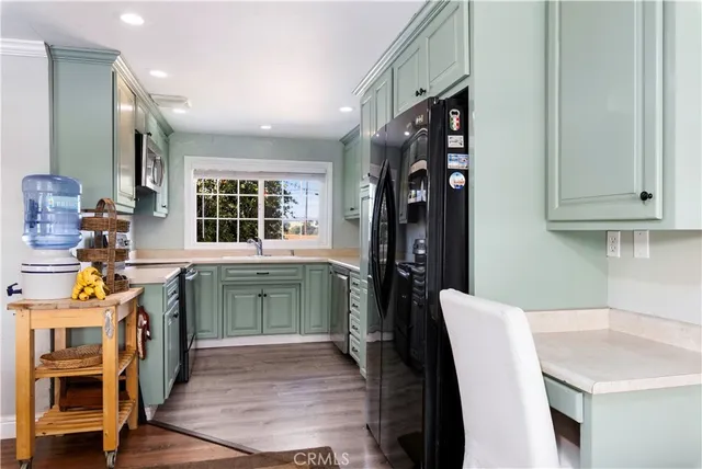 a kitchen with stainless steel appliances granite countertop a sink and a microwave
