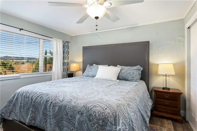 a bedroom with bed and a chandelier