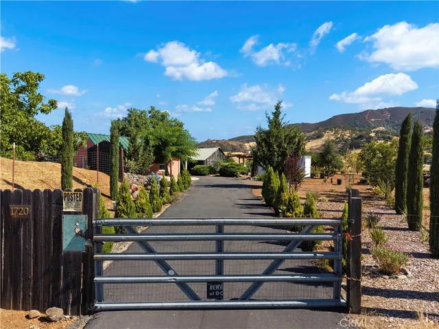 a front view of a house with yard and parking
