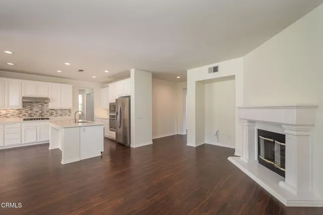 a view of a kitchen with a sink stove and a refrigerator
