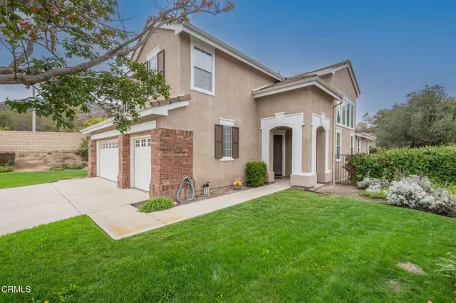 a front view of house with yard and green space