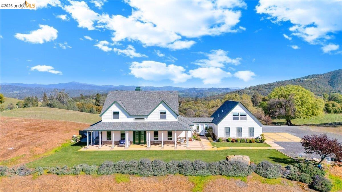 14814 Twist Road Jamestown, CA 95327 - Photo 1 of 60 view of front facade with covered porch, a front lawn, and a mountain view