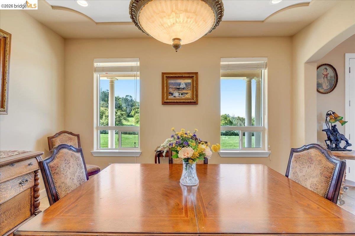 14814 Twist Road Jamestown, CA 95327 - Photo 17 of 60 a view of a dining room with furniture a potted plant and wooden floor
