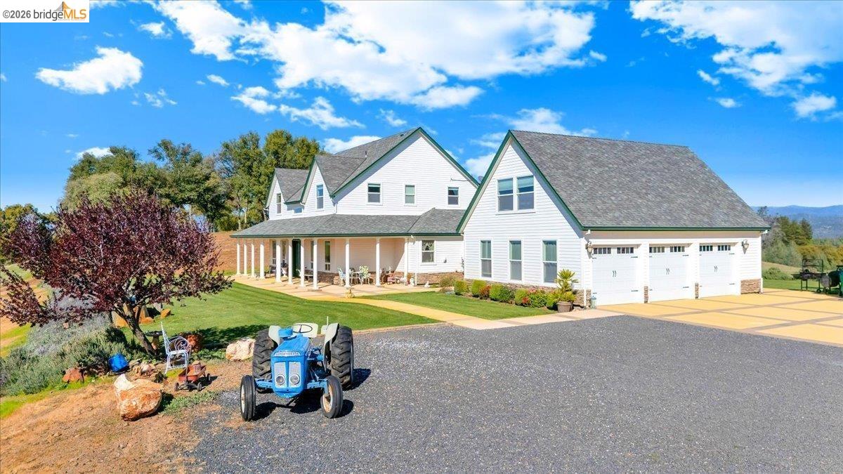 14814 Twist Road Jamestown, CA 95327 - Photo 3 of 60 view of front of home with a porch, concrete driveway, a front yard, and a shingled roof